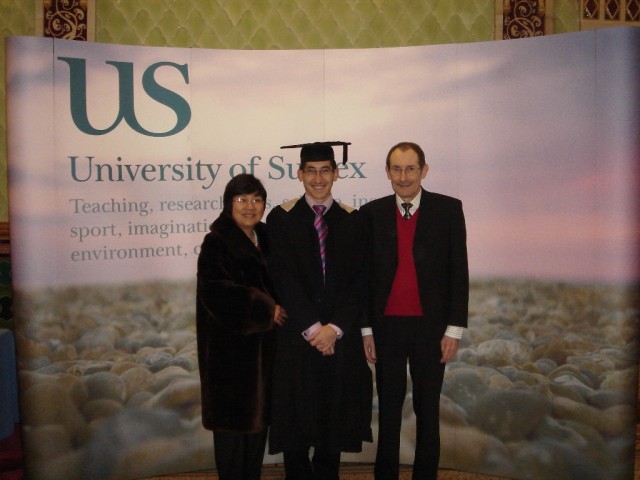 Family photography against the University of Sussex hoarding. 