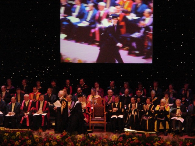 Aaron receiving his degree from Lord Attenborough. 