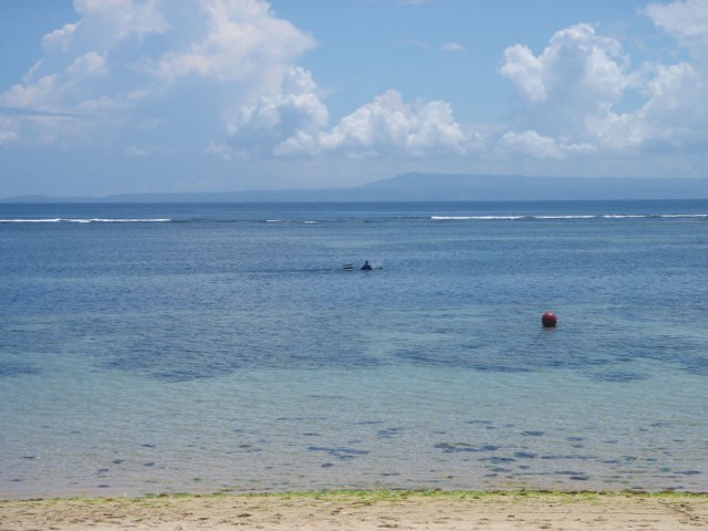 A fisherman can just be seen going about his business!
