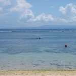 A fisherman can just be seen going about his business!