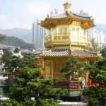 The gold pagoda sits in the middle of the garden, on a large pond.
