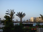 View of the resort from the main terrace area, over-looking the pool and bay in the back-drop.