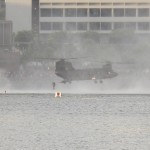 Almost touching the water, as it makes an air-drop out of the back.