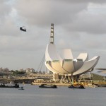 The Chinook flying behind the Arts Science museum and the Flyer
