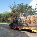 Some sort of festival carnival vehicle travelling by China Town